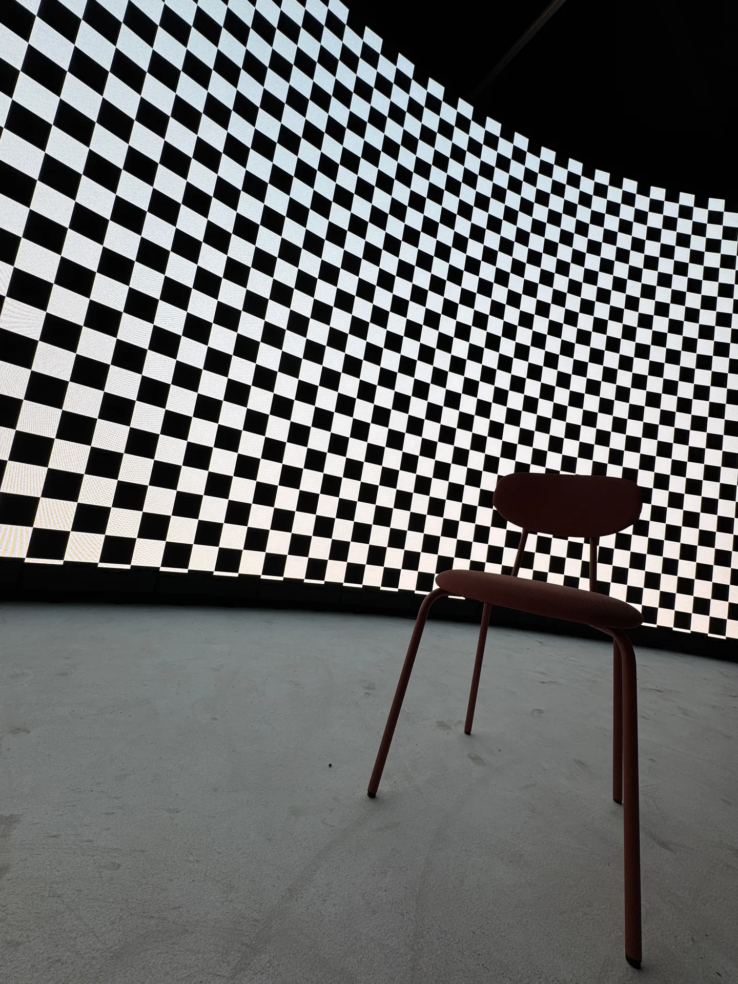 A chair in front of the curved LED wall running a checkerboard calibration pattern